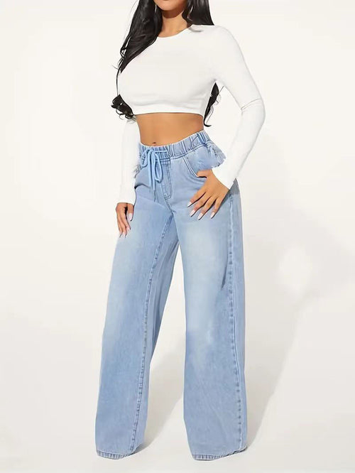 High waist wide leg jeans in light blue displayed on model, featuring a drawstring for adjustable fit and modern street style.