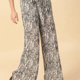 Stylish snake print wide leg pants with waist tie, perfect for a trendy outfit.